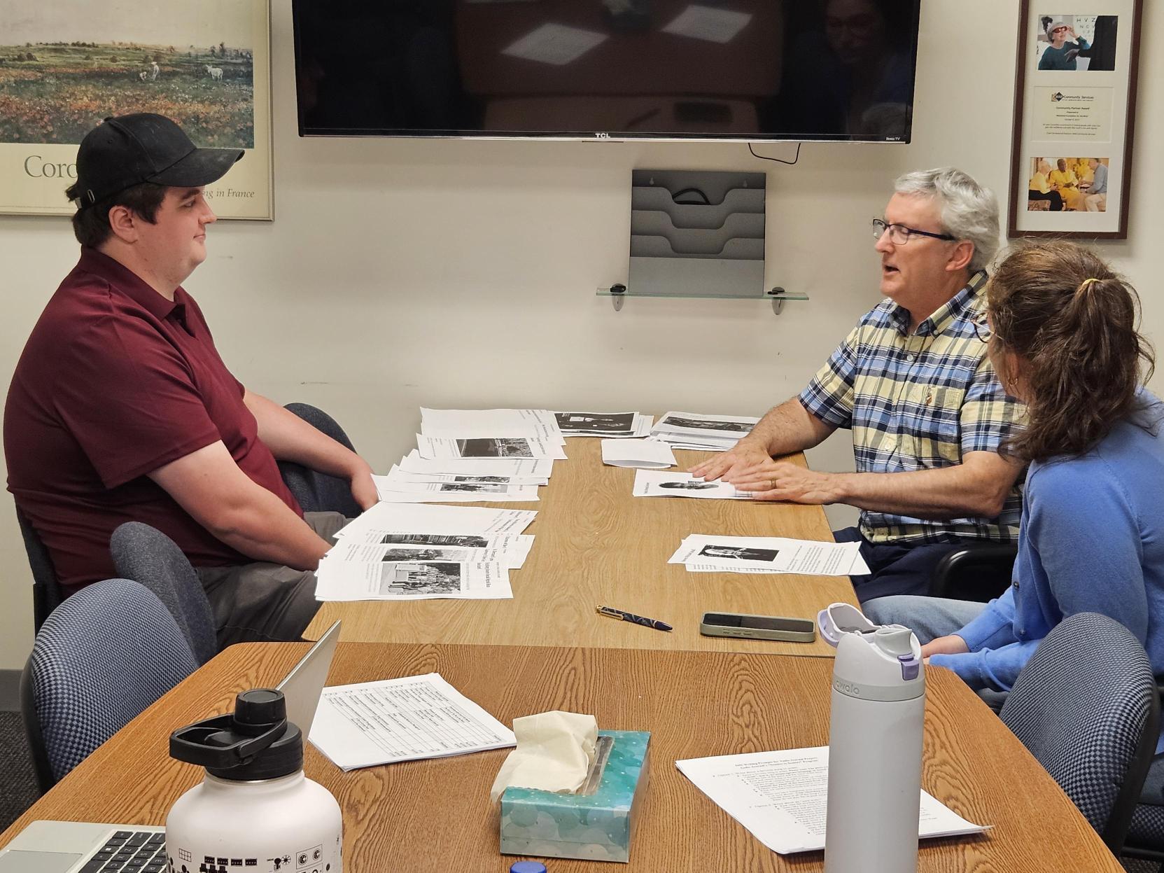A group of people talking in a meeting