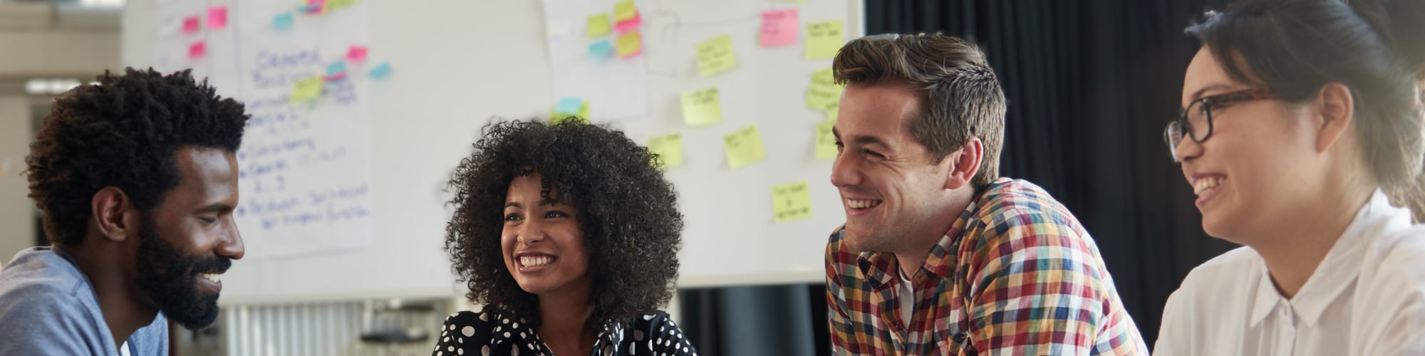 four people in a meeting